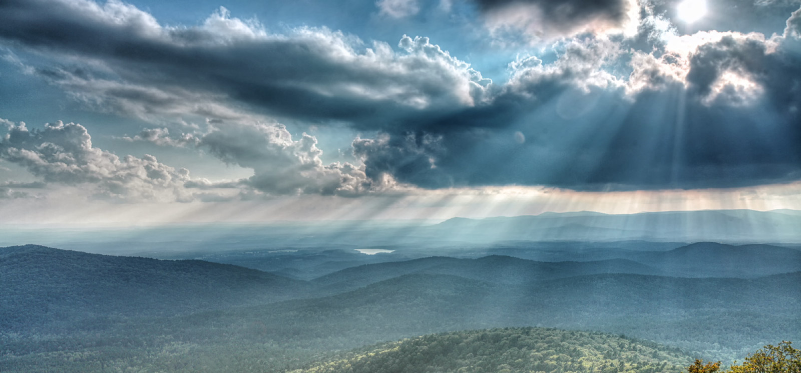 Beautiful landscape of the sun beaming through the clouds.