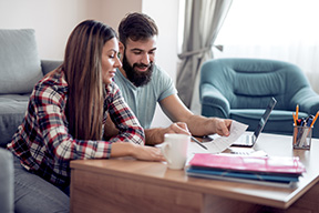 Couple reviewing paperwork in their livingroom.