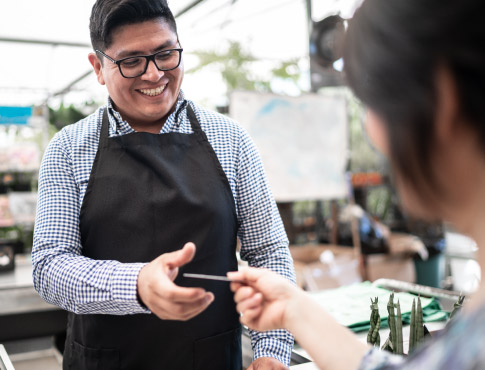 Woman pays joyful employee.