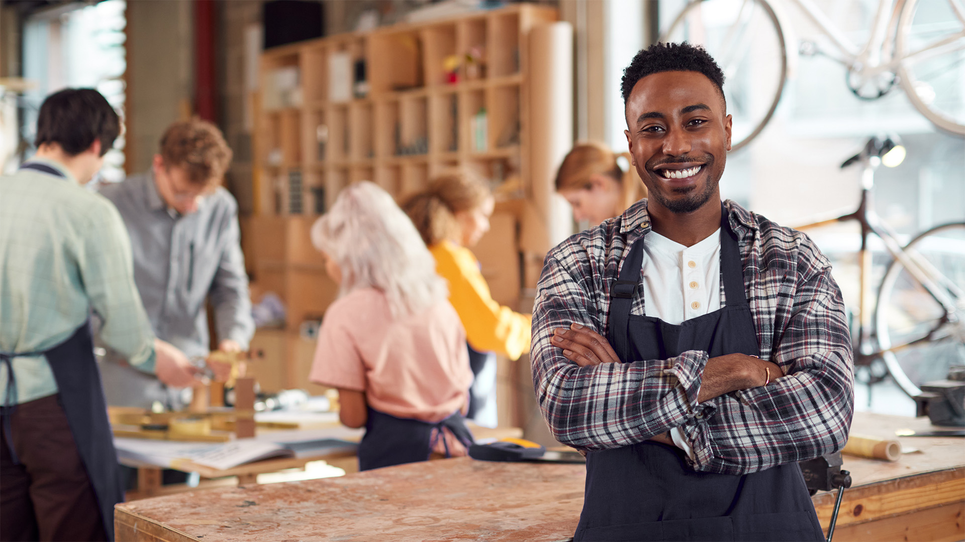 A shopkeeper or business owner smiling at the camera.
